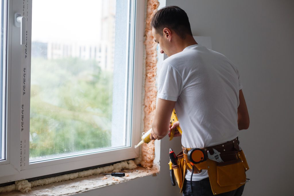 Window Installer Caulking a new window frame